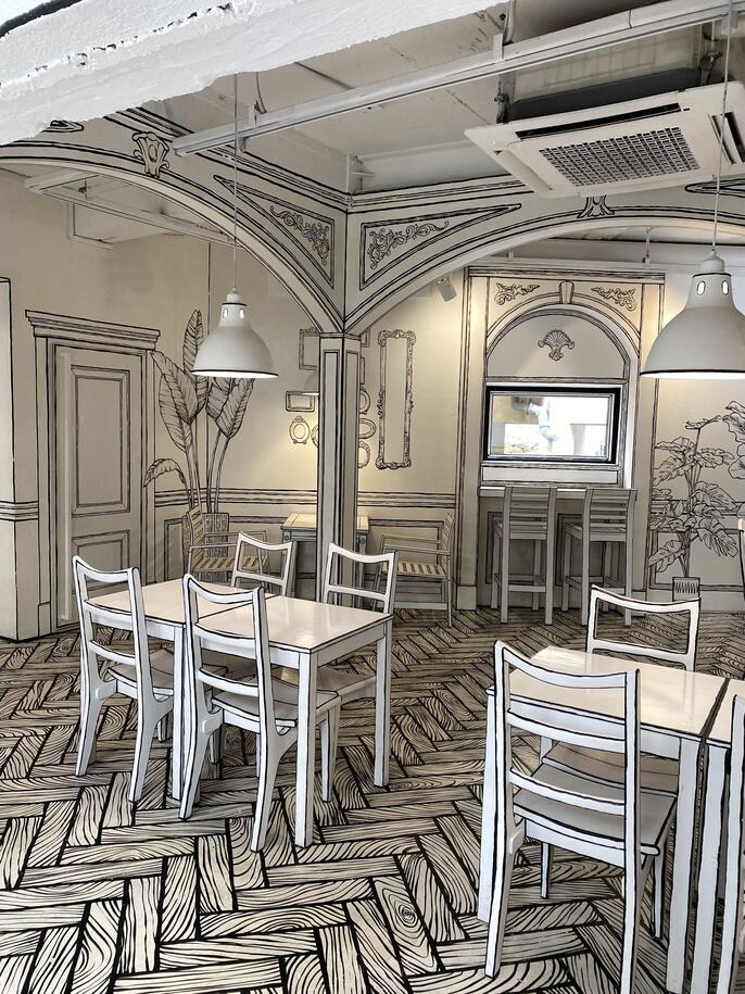 designer sketching in an unfamiliar cafe