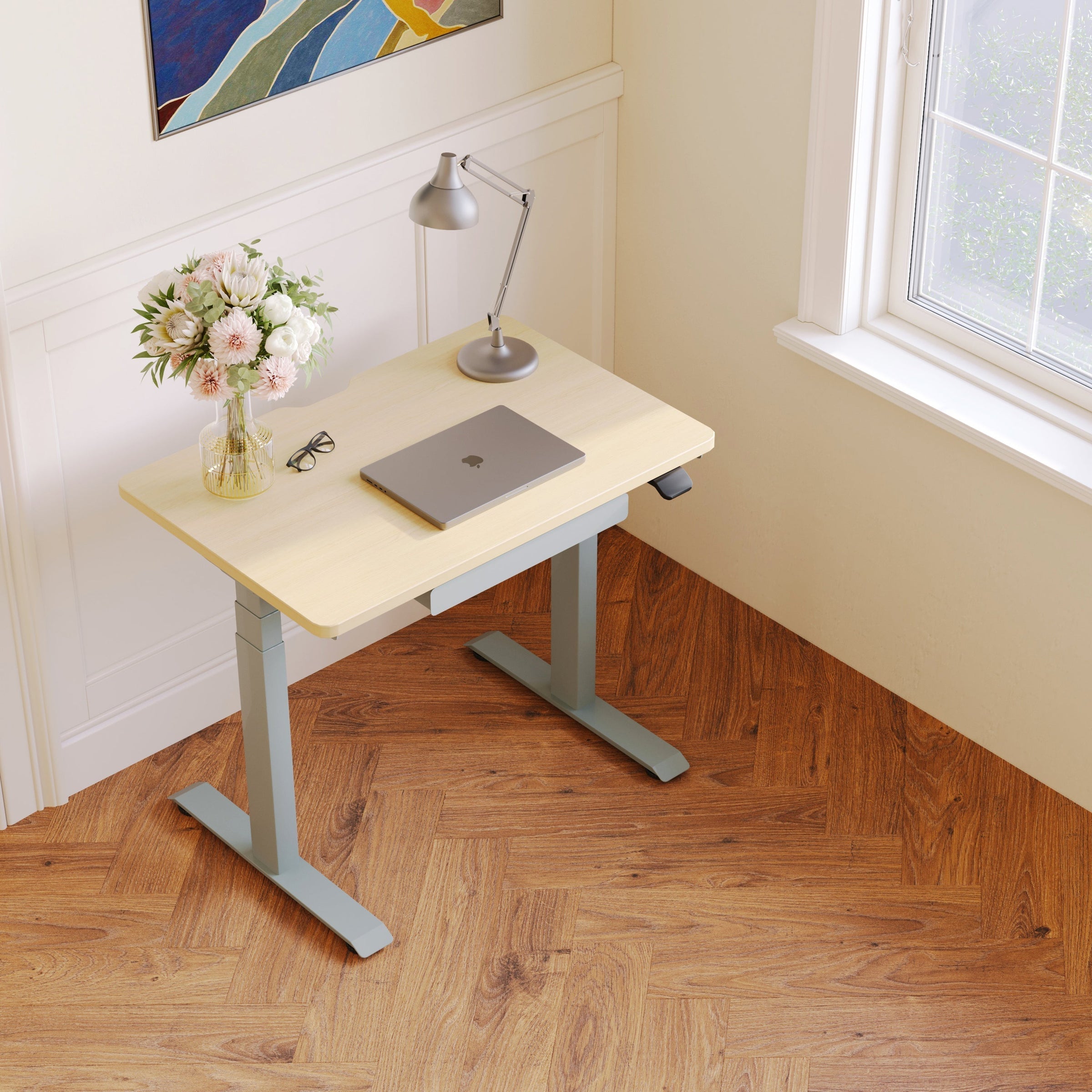 small wheeled desk tucked in apartment corner