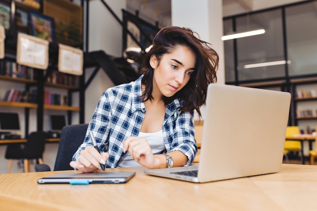 freelancer working from a library desk